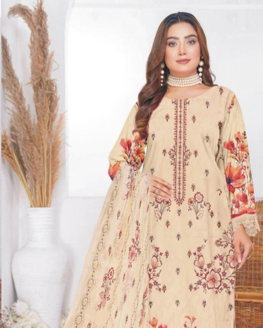 Woman wearing a beige embroidered outfit with floral patterns, standing against a white background.