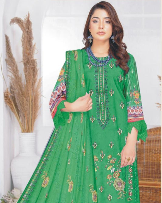 Green embroidered outfit with fabric details on a white background